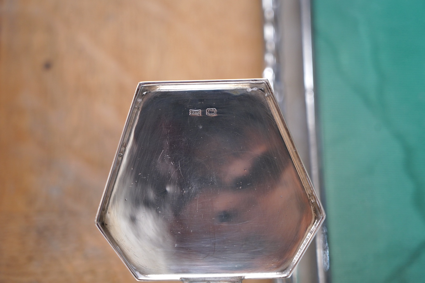 A George VI Art Deco silver mounted inkwell, Sheffield, 1949, 15.1cm and two early 20th century silver mounted rectangular photograph frames, largest 34.2cm. Condition - poor to fair